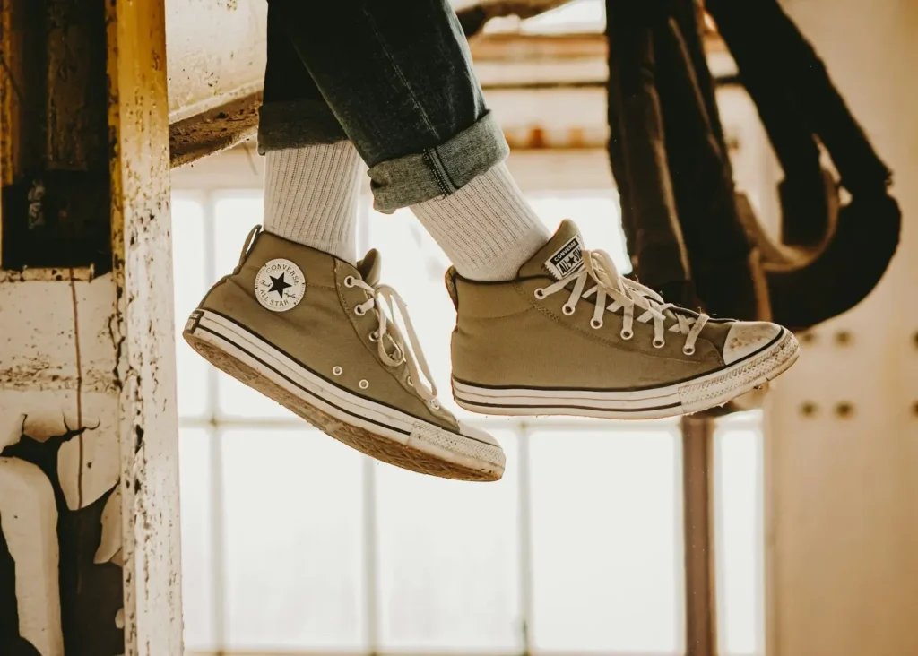 a pair of shoes hanging from the side of a building